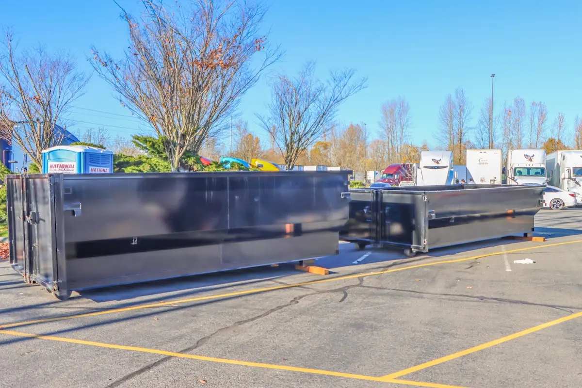 Professional dumpster rental service with roll-off container on residential driveway in Rainbow City